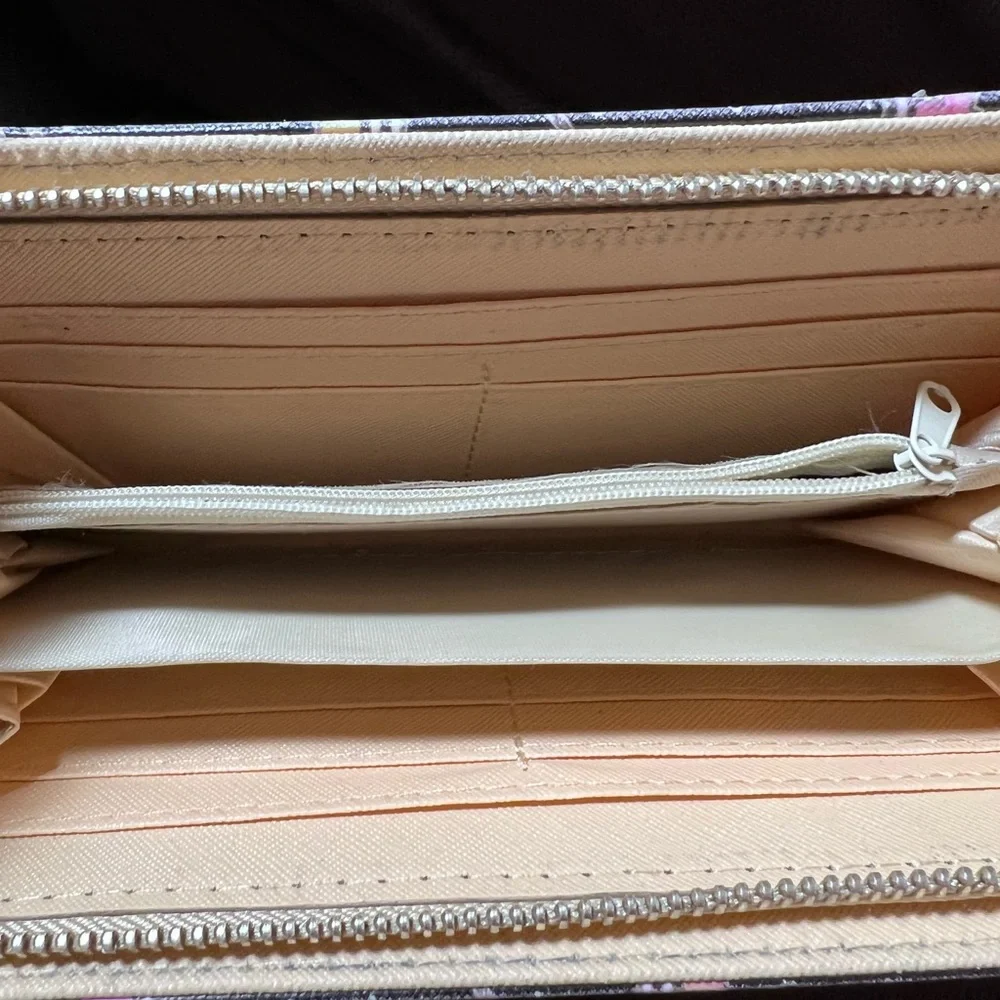 Simply southern wallet. Lots of slots for card and zips shut. Has some wear